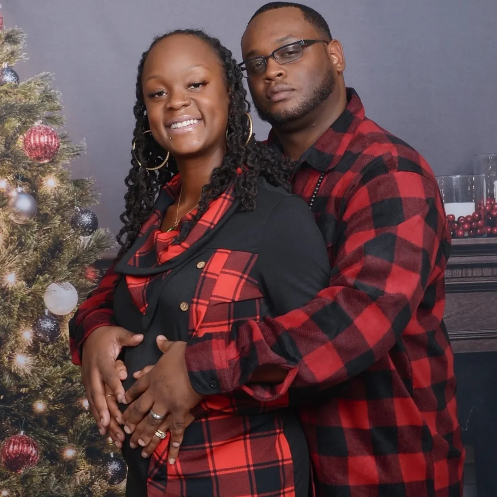 La’Zette and Nikia during pregnancy, with their hands together over her belly while expecting LaSaaun.